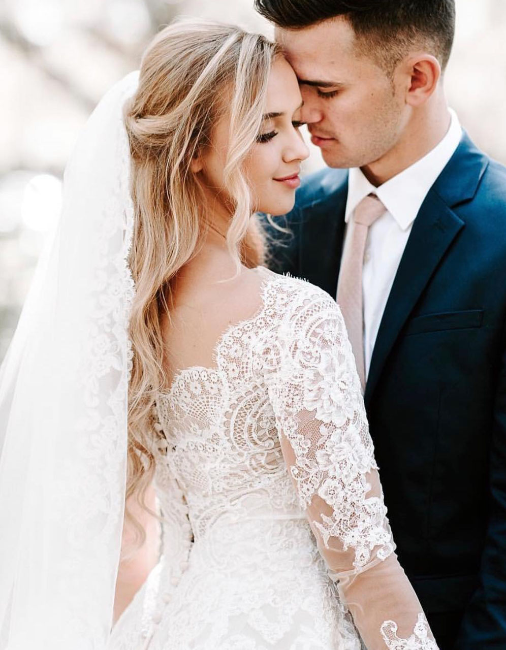 Сouple wearing a white gown and a black suit